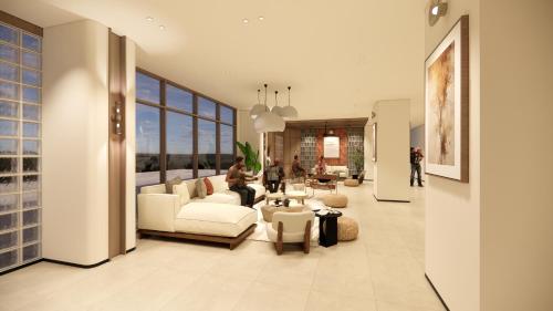 a living room with white furniture and a large window at Bogorienze City Resort in Pamoyanan