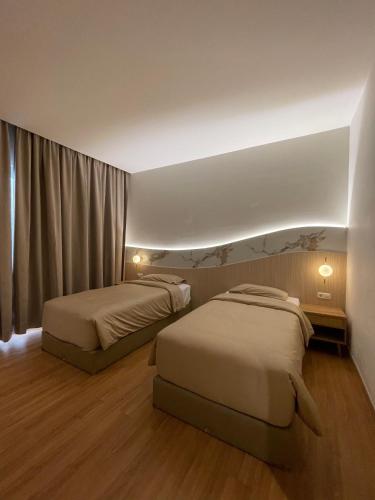 Ένα ή περισσότερα κρεβάτια σε δωμάτιο στο Innara Premium Guest House - Palangkaraya