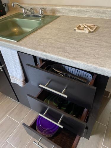 a kitchen counter with a sink and a drawer with wine bottles at LiV109 Norte Depa 7 Cd Obregon in Ciudad Obregón