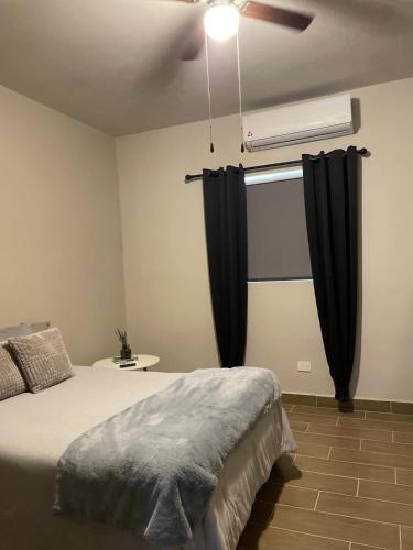 a bedroom with a bed and a ceiling fan at LiV109 Norte Depa 7 Cd Obregon in Ciudad Obregón