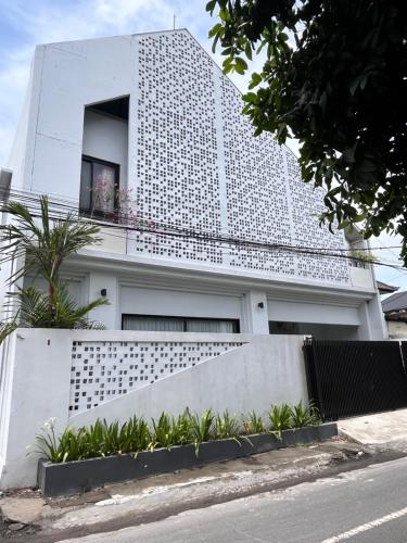 a white building with a window on top of it at Villa Jasmine in Seminyak