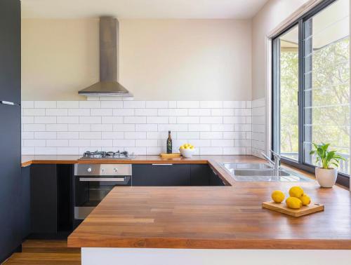 a kitchen with a counter with oranges on a cutting board at Tallebudgera Hinterland Retreat in Tallebudgera