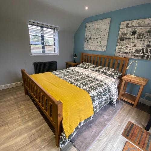 a bedroom with a bed with a yellow blanket at Cold Kitchen View in Longbridge Deverill