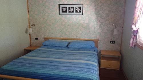 Un pat sau paturi într-o cameră la Punta Secca