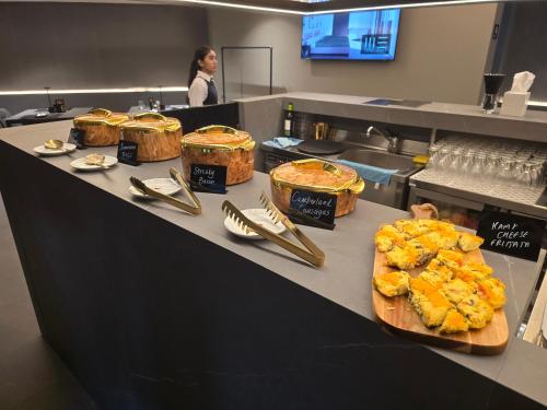 a counter with several different types of food on it at Thirty Three Boutique -Adults Only By K Hotels in St Julian's