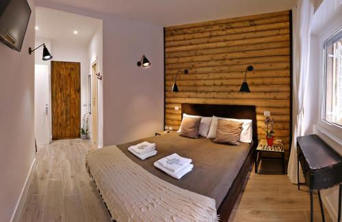 a bedroom with a large bed with a wooden wall at Antinori Vatican Suite in Rome