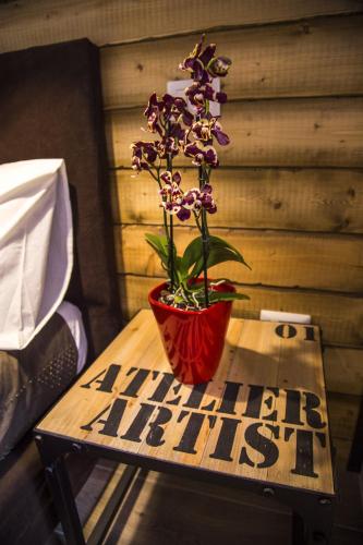 a wooden table with a vase with a plant on it at Antinori Vatican Suite in Rome