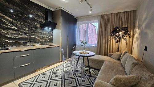 a living room with a couch and a table at Black Room Apartment in Mukacheve