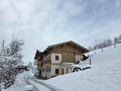 a house in the snow with a snow covered driveway at Chalet in Mittersill near Ski Slopes in Mittersill