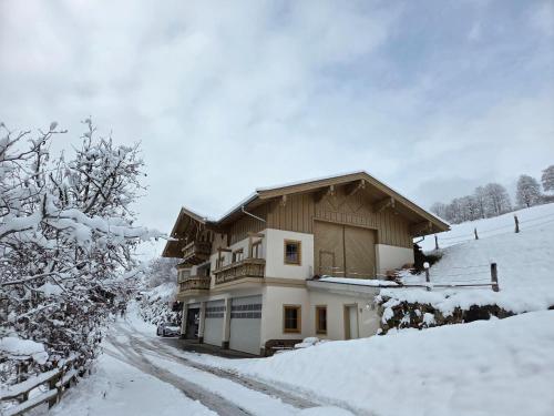 a house on a snowy hill with snow covered trees at Chalet in Mittersill near Ski Slopes in Mittersill