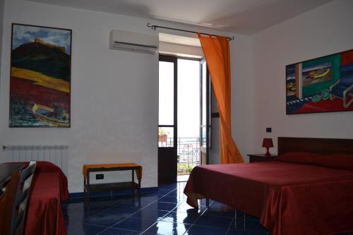 a bedroom with a red bed and a window at Bed& Breakfast Maredomus in Milazzo