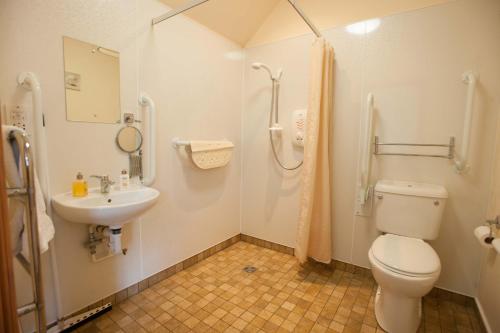 a bathroom with a toilet and a sink at Glenernan Self Catering Cottages in Ballater