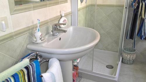 a white sink in a bathroom with a shower at Suite Civitanova in Civitanova Marche