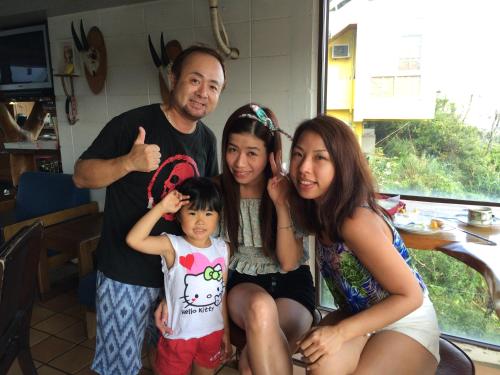a family is posing for a picture together at Surfside Bed & Breakfast in Onna