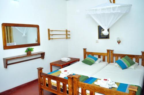 Uma cama ou camas num quarto em Heritage Walawa Resort