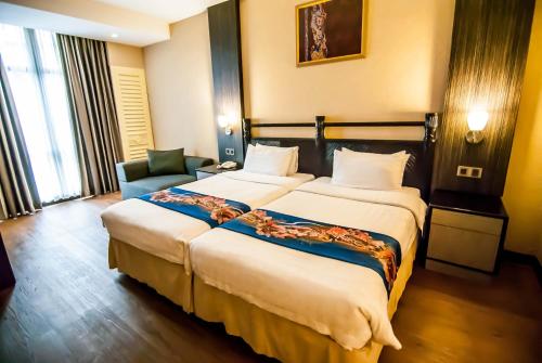 Ένα ή περισσότερα κρεβάτια σε δωμάτιο στο KK Times Square Hotel