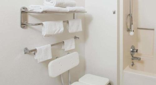 a bathroom with a white toilet and towels at Super 8 By Wyndham Wayne in Wayne