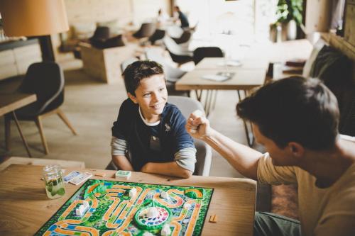 two men sitting at a table playing a board game at Arabella Retreat & Spa in Nauders