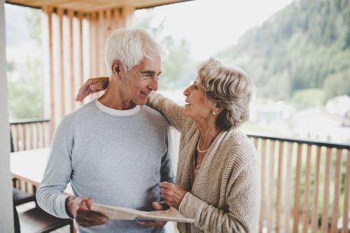 a woman and an older man standing on a porch at Arabella Retreat & Spa in Nauders