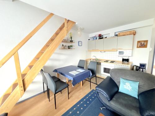 a kitchen and a living room with a table and chairs at Ferienwohnung Sonnenperle - Wohnung 13 in Breege