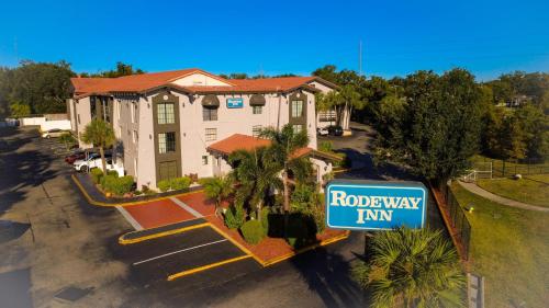 a house with a road way sign in front of it at Rodeway Inn Near Ybor City - Casino in Tampa