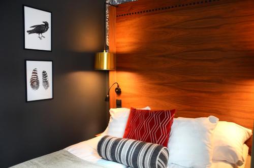 a bedroom with a bed with a wooden headboard at Home Hotel Temperance in Malmö