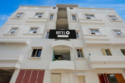 MancheshwarHotel O Palasuni Bridge Bhubaneswar Formerly Ganpat的一座挂着招牌的白色大楼