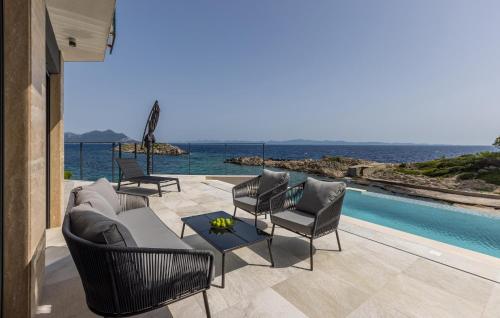 a patio with chairs and a table next to a pool at Cozy Home In Dingac With Sauna in Gornji Dingač