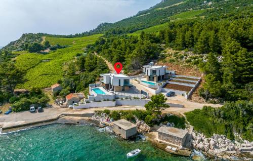an aerial view of a house on a hill next to the water at Cozy Home In Dingac With Sauna in Gornji Dingač