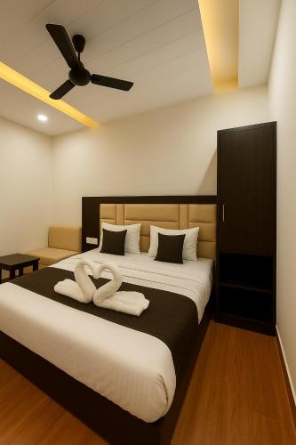 a bedroom with a bed with two towels on it at Hotel KABIR ROYAL-5 MIN WALK TO GOLDEN TEMPLE in Amritsar