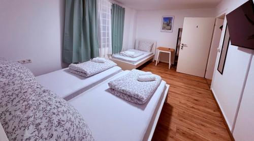 a bedroom with two beds and a room with a window at 92 City Rooms in Koblenz