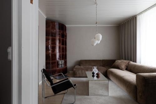 a living room with a couch and a table at Stylish & Cozy 1BR Apt in Historical Neighborhood in Tampere