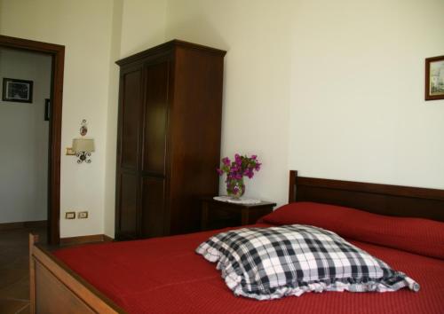 a bedroom with a red bed with a red blanket at Tenuta Camporosso in Massa Lubrense