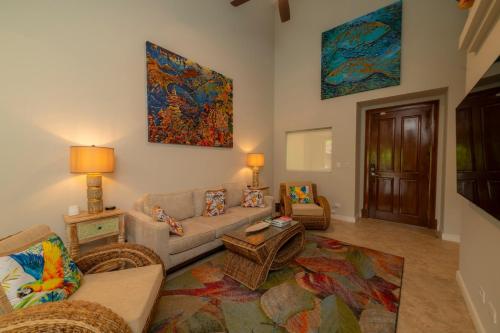 a living room with a couch and a table at Veranda 4B - 3bdr 3bath in Isla Herradura