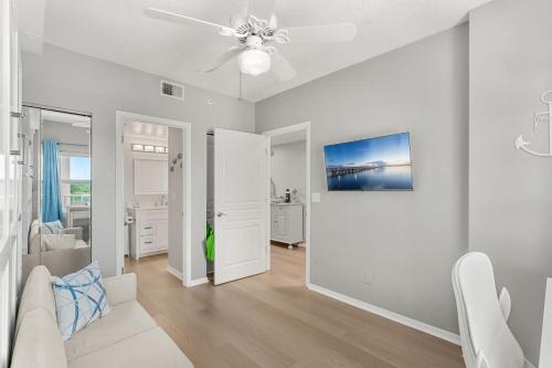 a living room with a couch and a ceiling fan at Ocean Oaks PHB-8 in Cape Canaveral