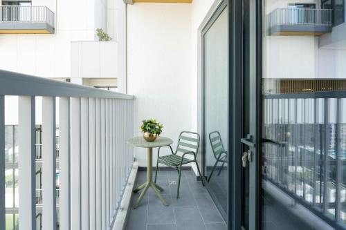 a balcony with a table and chairs on a building at Luxury 1BR Apartment - Pool View - The Crest Dubai in Dubai