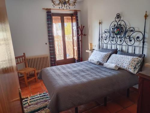 Ένα ή περισσότερα κρεβάτια σε δωμάτιο στο Casa Rural La Argentina