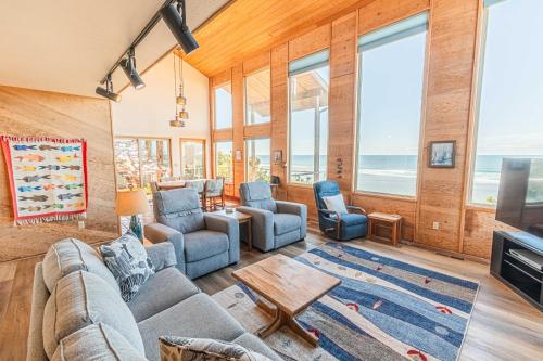 a living room with a couch and chairs and a television at RidgeTop in Lincoln City
