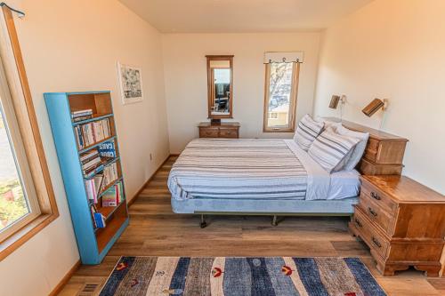 a bedroom with a bed and a book shelf at RidgeTop in Lincoln City