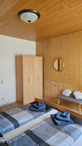 a bedroom with two beds and a mirror at Apartmenthaus-Winkler Wiener Neustadt Umgebung 