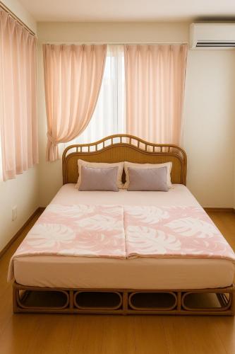a bed in a bedroom with a large window at Riverside Mizukiリバーサイドミズキ in Uruma