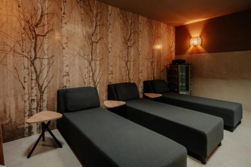 a waiting room with two beds and two chairs at Parkhotel Papenburg by Hackmann in Papenburg