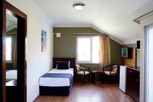 Ένα ή περισσότερα κρεβάτια σε δωμάτιο στο Sunlight Garden Hotel