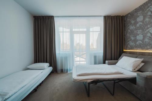 Ένα ή περισσότερα κρεβάτια σε δωμάτιο στο Rodinný Hotel Hubert High Tatras