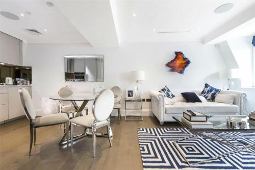 a living room with a couch and a table at Prime West End The Covent Garden Design Flat in London