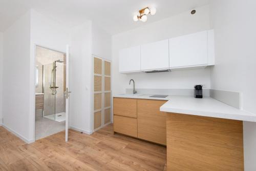 a white kitchen with a sink and a shower at New Panoramic studio overlooking Monaco in Beausoleil