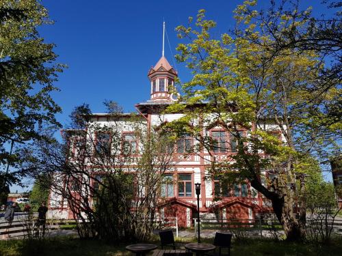 an old building with a tower on top of it at Hostel Cafe Huvila in Oulu