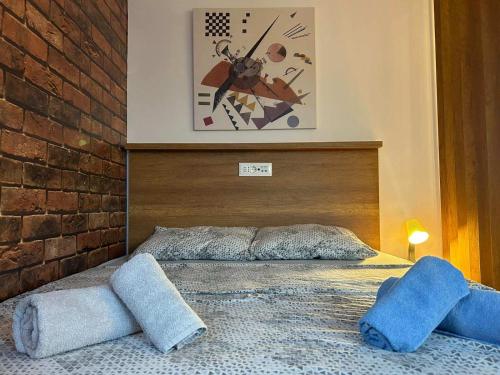 a bedroom with a bed with two pillows on it at Centar Crnjanski 2 in Jagodina