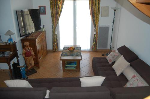 a living room with a couch and a table at Villa Aghjanella in Patrimonio