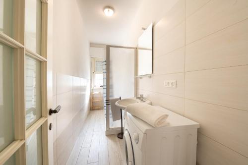 a white bathroom with a sink and a mirror at Green Marine in Silvi Marina